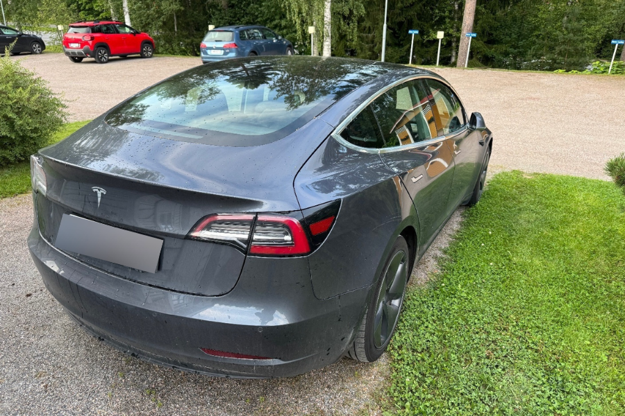 Car photo taken in dealership parking lot before editing